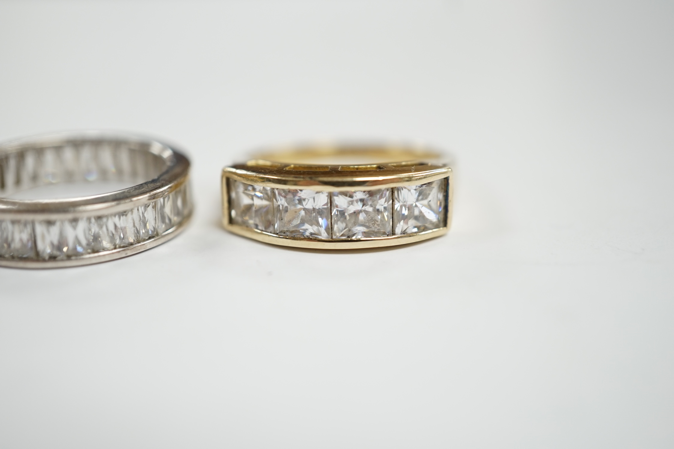 A 9k and simulated diamond set half hoop ring and a 925 and simulated diamond set eternity ring.